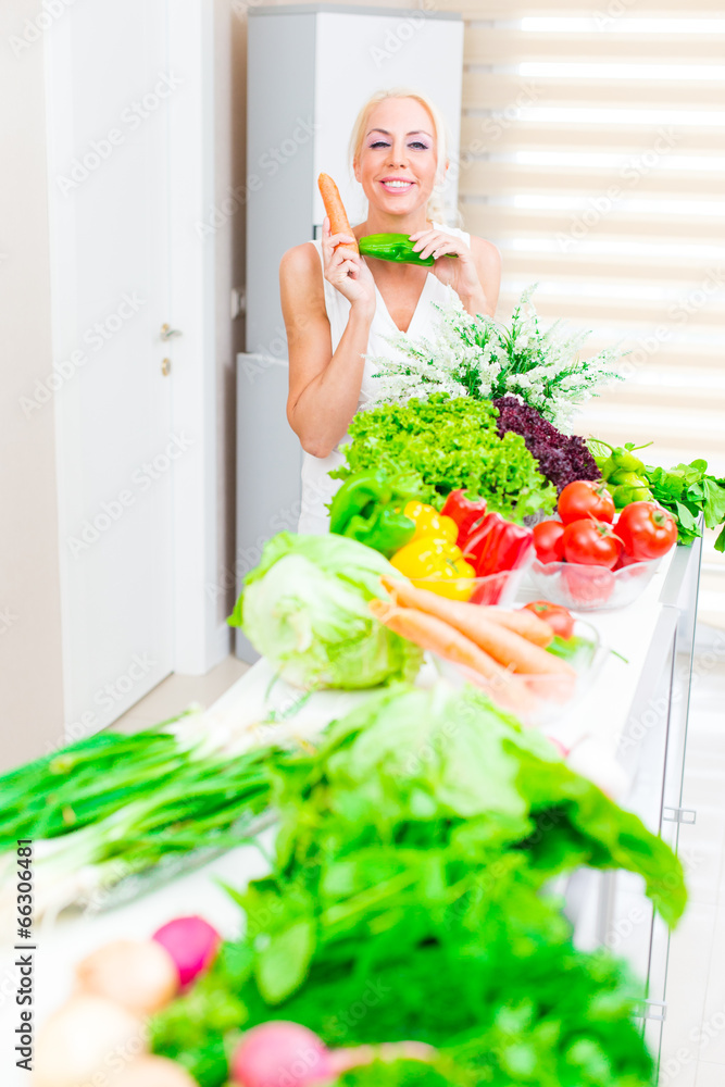 Happy woman cooks in the kitchen Happy woman cooks in the kitchen