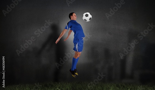 Composite image of football player in blue jumping © WavebreakmediaMicro