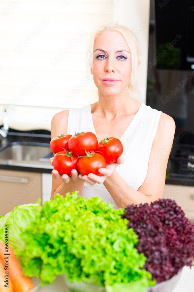 Happy woman cooks in the kitchen Happy woman cooks in the kitchen