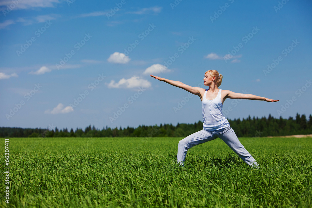Beautiful healthy young woman doing yoga exercise on field. Yoga Beautiful healthy young woman doing yoga exercise on field. Yoga