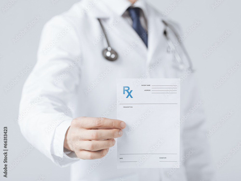 male doctor holding rx paper in hand - obrazy, fototapety, plakaty 