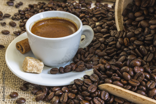 fresh espresso coffee in white cup with lump sugar  cinnamon and