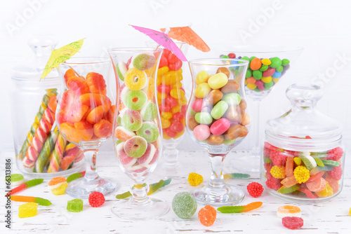 Different colorful fruit candy in glasses