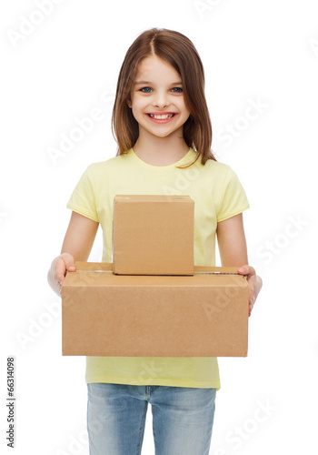 smiling little girl with many cardboard boxes