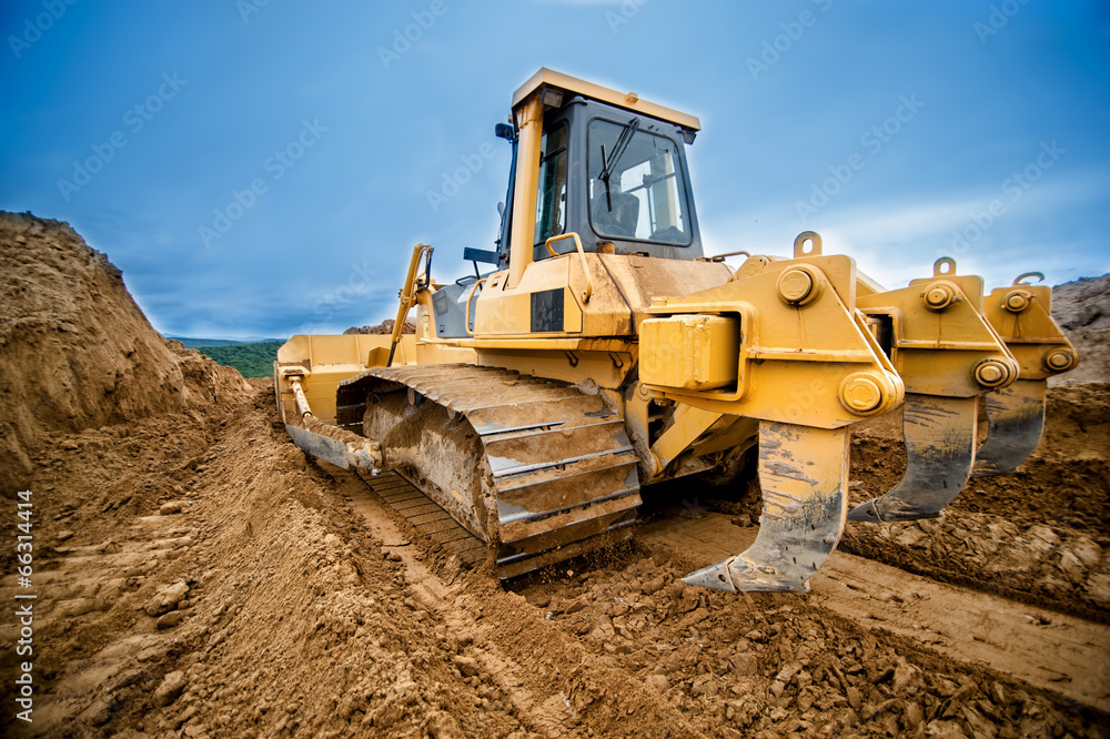 close-up of bulldozer or excavator working with soil on highway