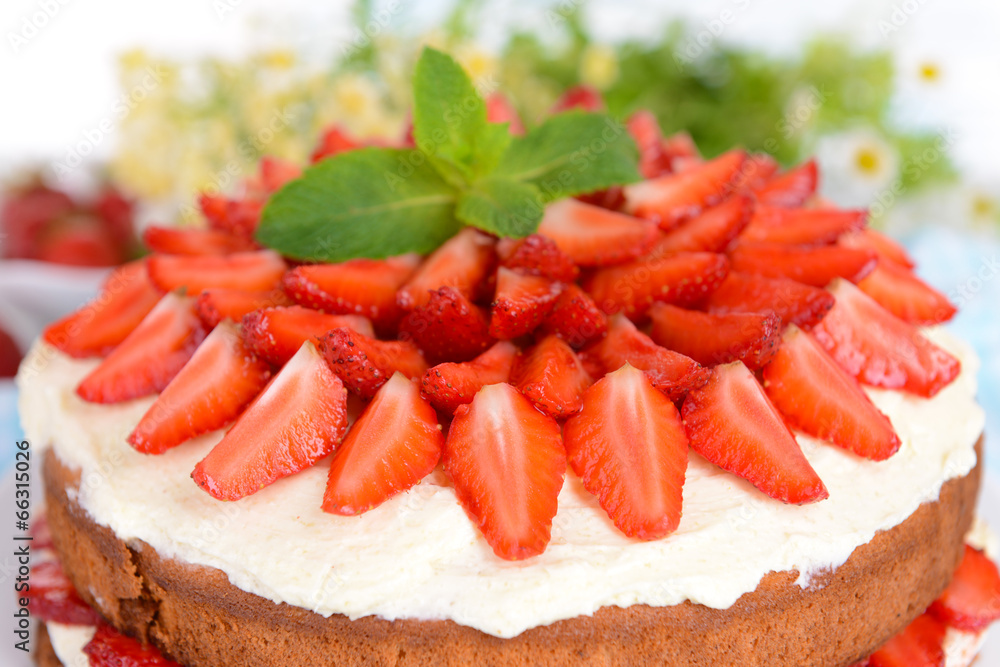 Delicious biscuit cake with strawberries on table close-up Delicious biscuit cake with strawberries on table close-up