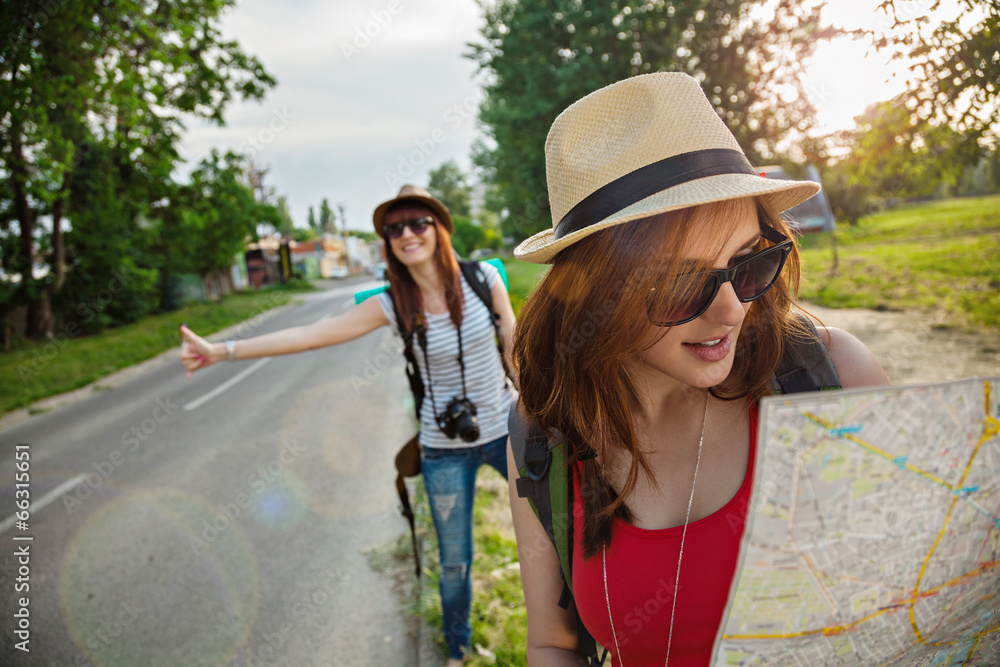 Two Tourist Girl Hitchhiking