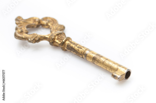 Old golden key on white background