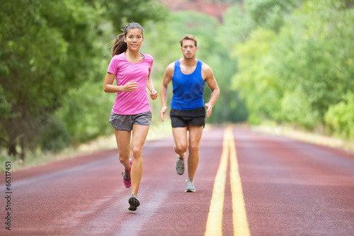 Sport - couple running on road training marathon
