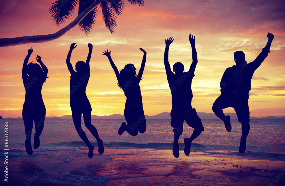 Young People Jumping with Excitement on the Beach