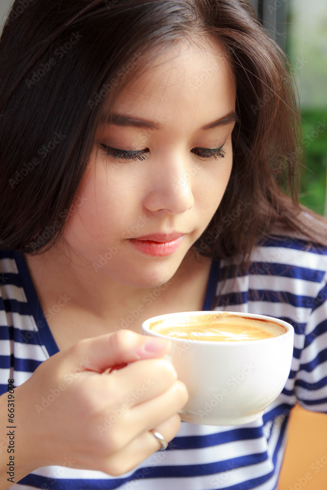 Woman drinking coffee in a cafe Woman drinking coffee in a cafe