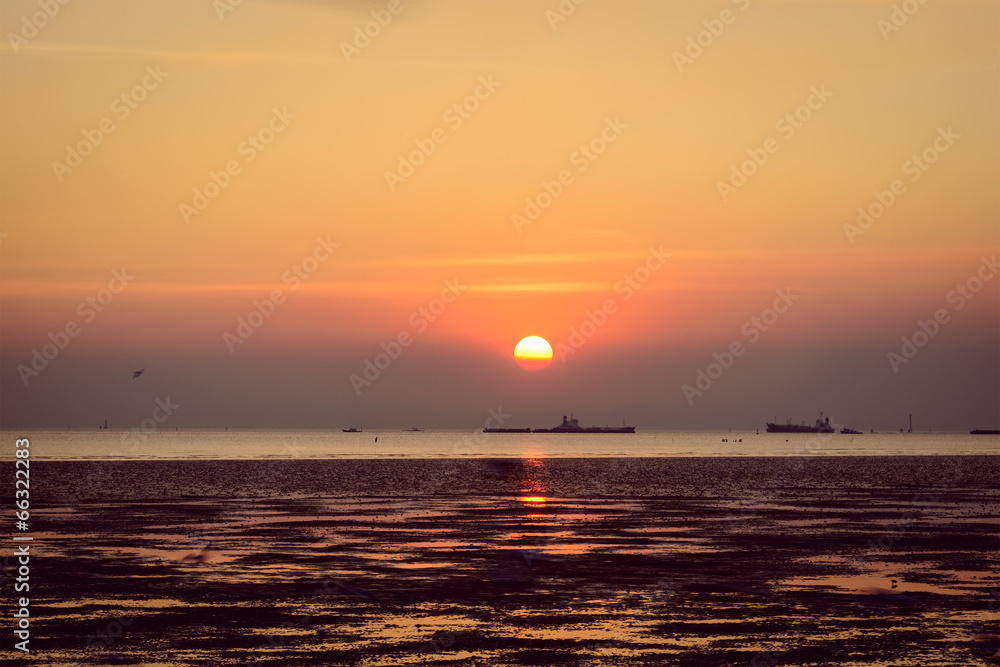 Scenic view of beautiful  sunset sea in summer with cargo ship