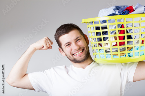 Happy man doingg laundry photo