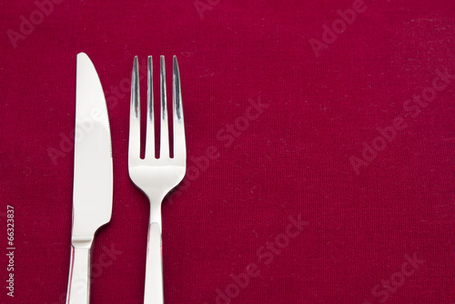 Knife and fork on red tablecloth