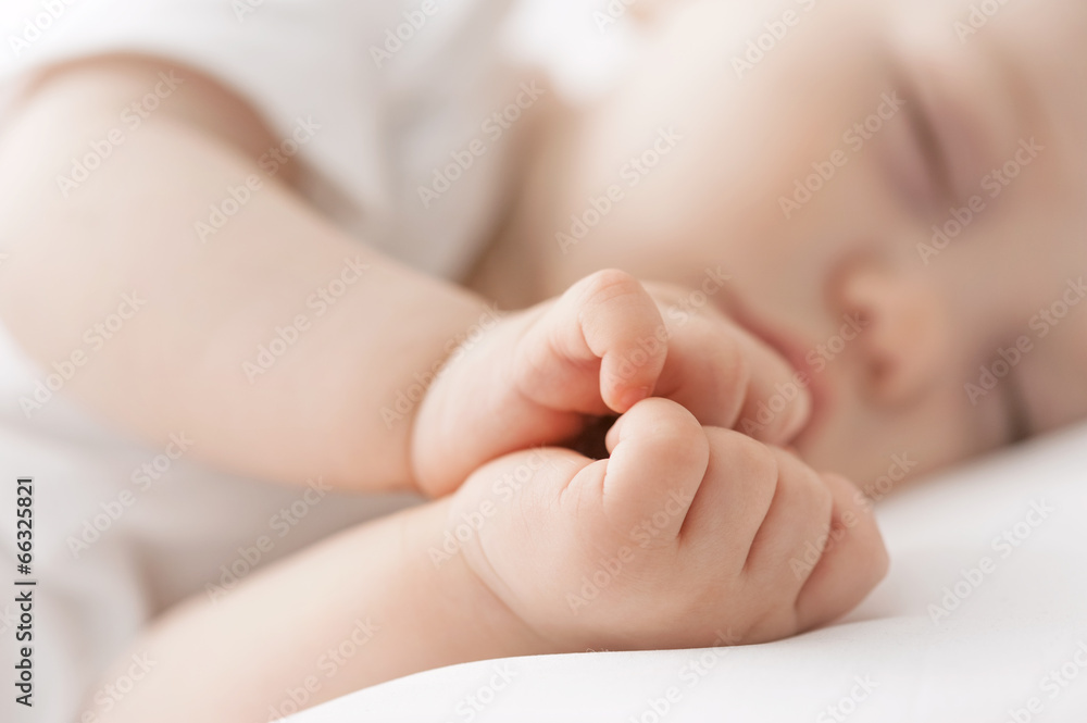 Carefree sleep little baby with a soft toy on the bed