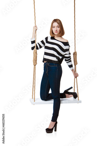 Beautiful girl swinging on swing. Isolated