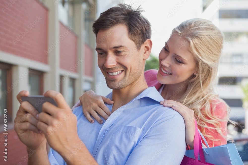 Stylish young couple looking at smartphone Stylish young couple looking at smartphone