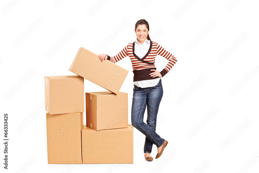 Happy woman standing by a bunch of boxes Happy woman standing by a bunch of boxes