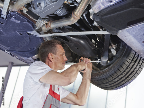Motor mechanic inspecting the engine of a car