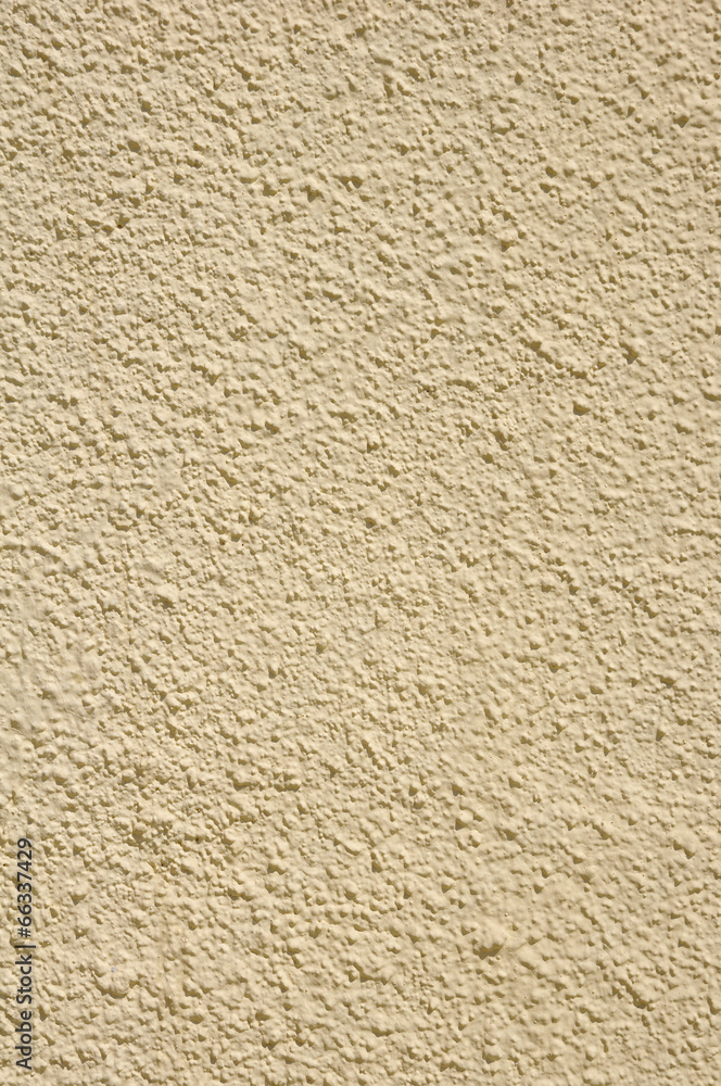 Yellow rough plaster on wall closeup Yellow rough plaster on wall closeup