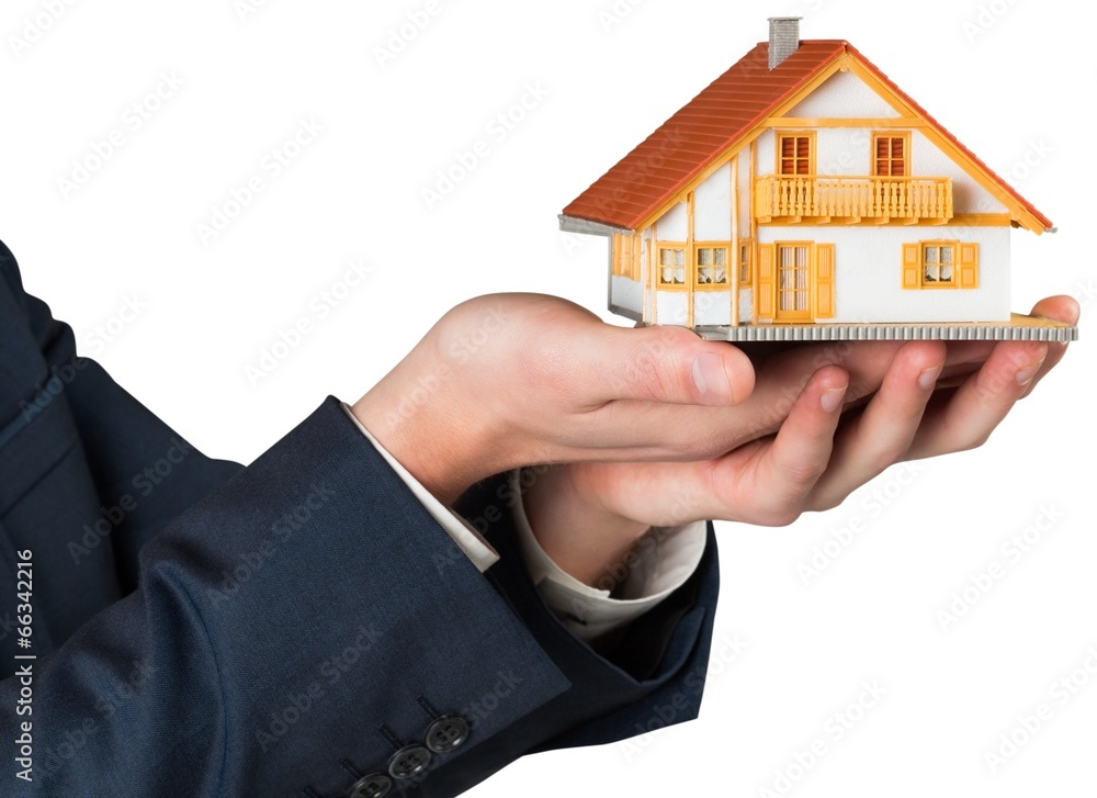 Businessman holding miniature house model Businessman holding miniature house model