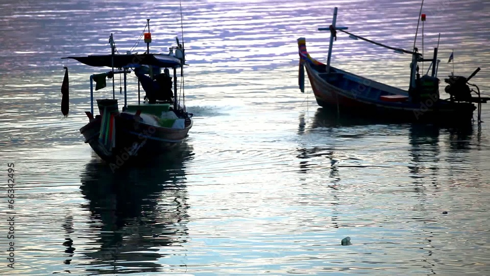 Thai fisherman prepares to sail for Fish in the sea at sunset Thai fisherman prepares to sail for Fish in the sea at sunset