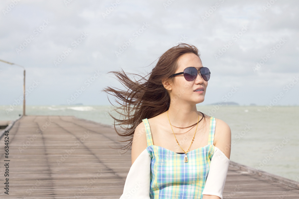 Beautiful girl in sunglasses on background of the sea Beautiful girl in sunglasses on background of the sea