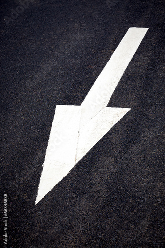 White forward traffic arrow on road