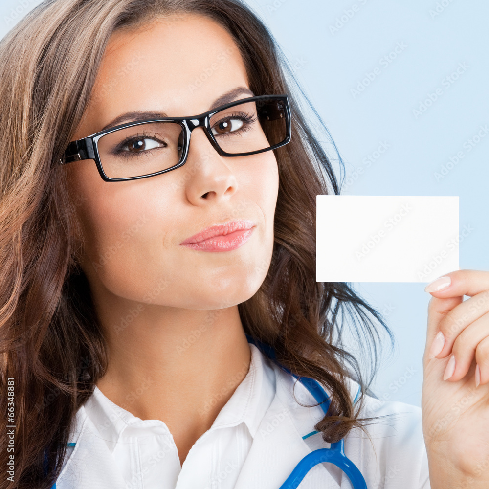 Young female doctor showing blank business card