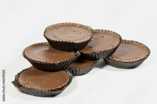 Pile of Six Brown Chocolates in Protective Papers