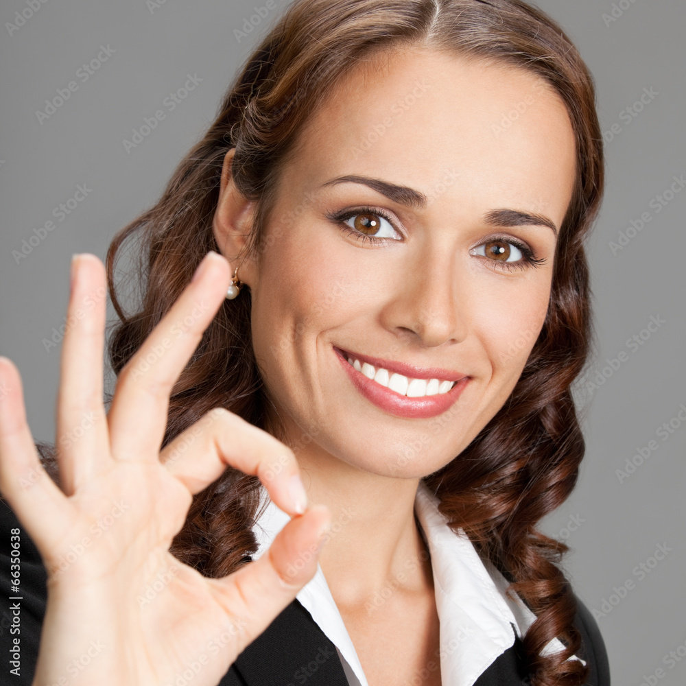 Young businesswoman showing okay gesture Young businesswoman showing okay gesture