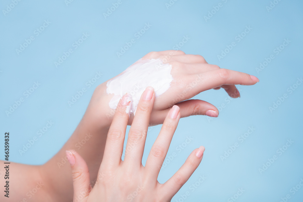 Naklejka premium Skin care. Female palms with moisturizing cream.