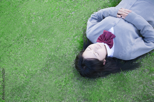 芝生で眠る高校生