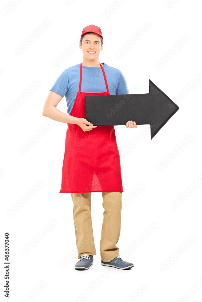Man in apron holding a big black arrow Man in apron holding a big black arrow