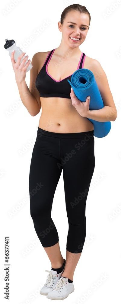 Fit brunette holding mat and sports bottle Fit brunette holding mat and sports bottle