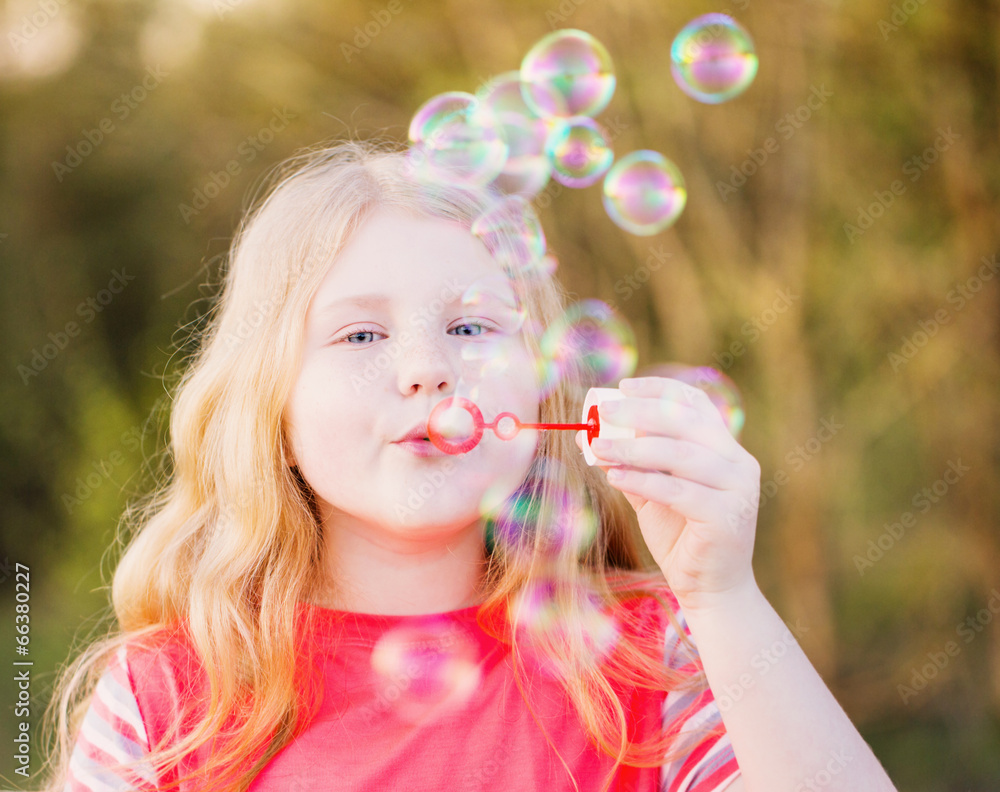 girl blowing soap bubbles outdoor at sunset girl blowing soap bubbles outdoor at sunset