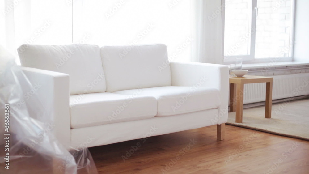 male putting down new sofa at home male putting down new sofa at home