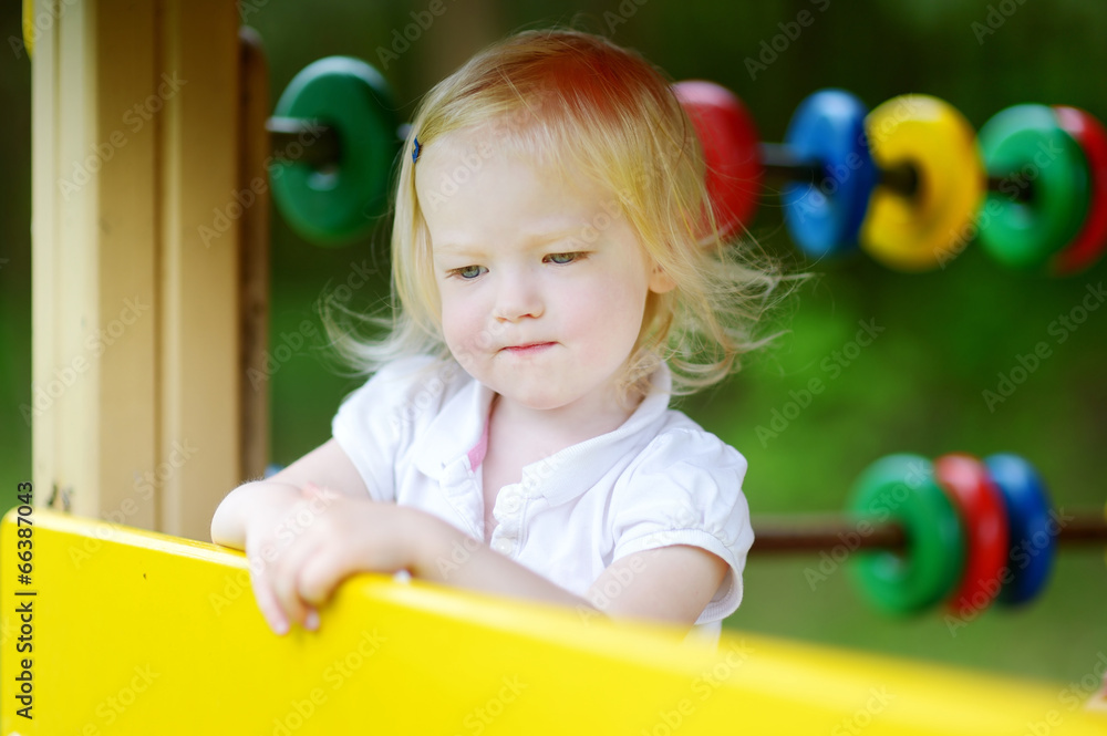 Little girl having fun at a playground Little girl having fun at a playground