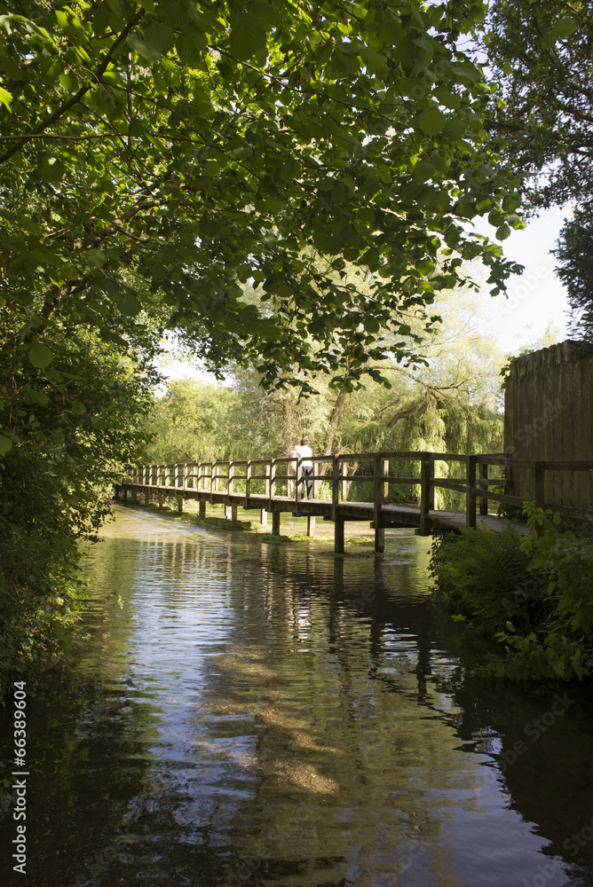 Wooden bridge spanning the River Test Hampshire England UK Wooden bridge spanning the River Test Hampshire England UK
