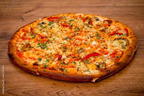 Delicious fresh pizza served on wooden table