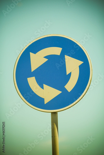Circular junction road sign in blue
