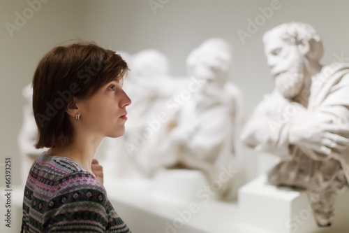 Photography woman looking ancient sculptures