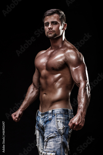 athletic young man on black background © Anatoly Repin