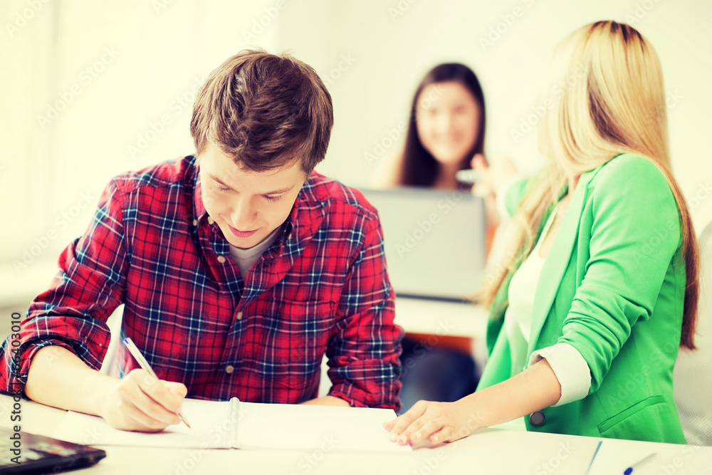 students writing something at school students writing something at school