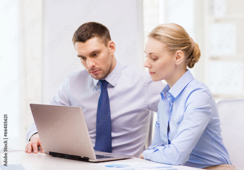 business team working with laptop in office business team working with laptop in office