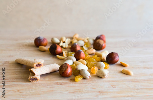 Nuts, jam sticks, rasin on a wooden board