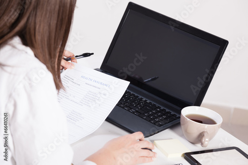 Female doctor working in office