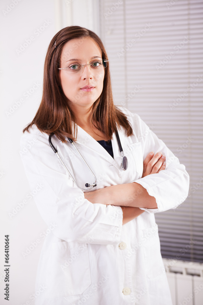 Female doctor smiling and working in office Female doctor smiling and working in office