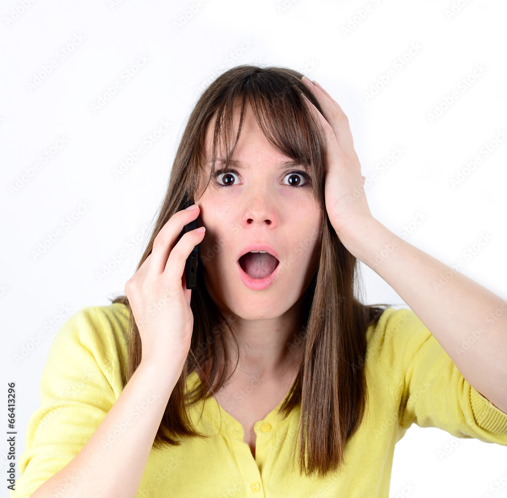 Beautiful woman talking on cellphone and being in shock of news Beautiful woman talking on cellphone and being in shock of news
