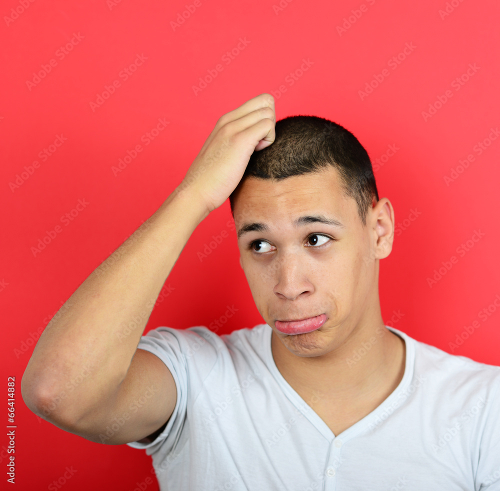 Portrait of clueless man against red background Portrait of clueless man against red background